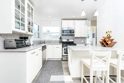 The bar area with bar stools is a perfect additional seating area so the house chef can cook with an audience!