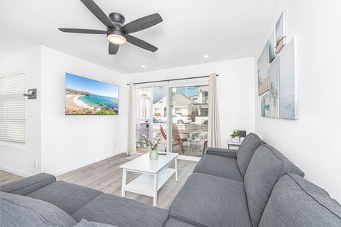 The main living area include a large L-shape sofa, streaming TV, and access to the front patio.