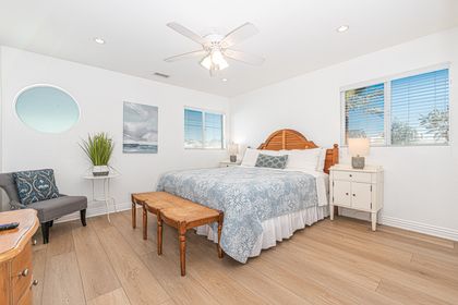 The primary bedroom includes king bed, Roku TV, ceiling fan, and en suite bathroom.