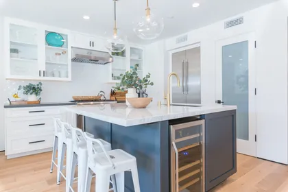 Open to the main living spaces, the spacious kitchen offers island seating and plenty of room for meal prep and casual gathering