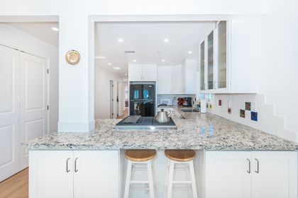 The kitchen comes with plenty of storage and includes barstool seating, making meal prep a social affair.