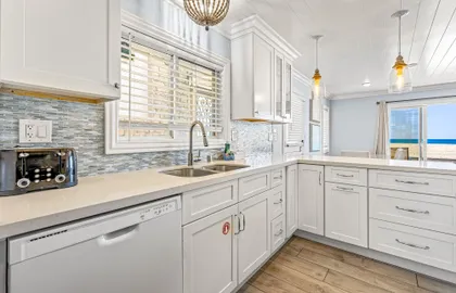 Enjoy a bright coastal kitchen with modern finishes and plenty of space to prep meals after a day at the beach.