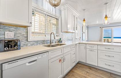 Enjoy a bright coastal kitchen with modern finishes and plenty of space to prep meals after a day at the beach.