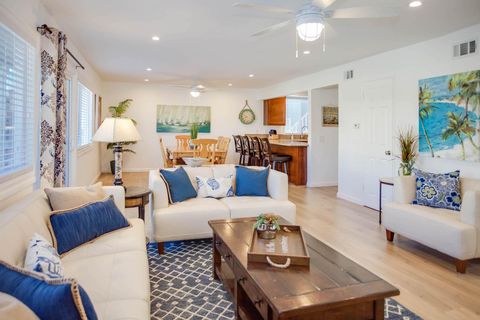 Main living spaces looking from front entry area. Open floor plan between living, kitchen and dining areas.
