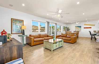 The upstairs main living space looking from front entry area. Enjoy an open floor plan between the living, kitchen and dining areas.