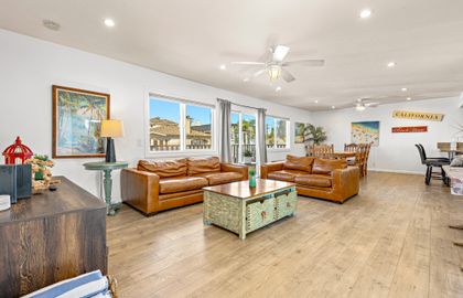 Main living spaces looking from front entry area. Open floor plan between living, kitchen and dining areas.