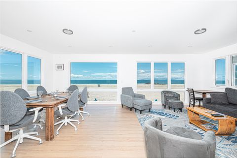 Large front windows showcase the beach from every angle of the dining and living areas.