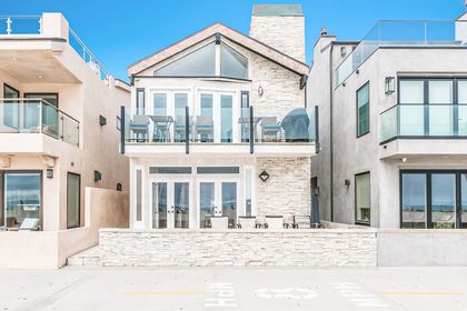 The exterior of this two-level vacation home with plenty of outdoor and indoor space for the whole group. There's even a propane BBQ grill for evening cookouts!
