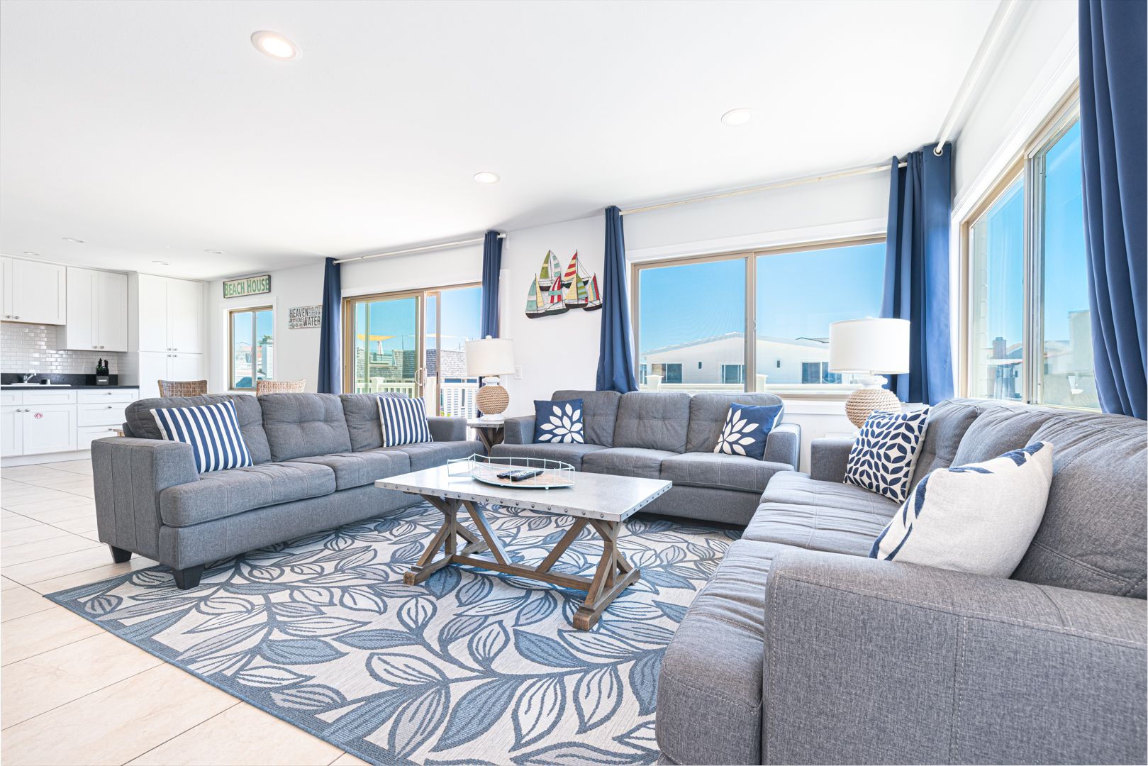 The main living area includes a sofa set, cable TV, and sliding glass doors that open up to the front balcony.