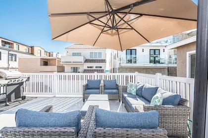 Private deck lounge beneath a market umbrella, perfect for sunset gatherings