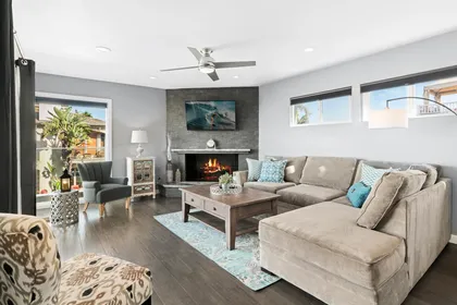 Main upper level living room of front main house, with ocean views, comfy seating, TV, fireplace. Access to front ocean view balcony and outdoor seating.