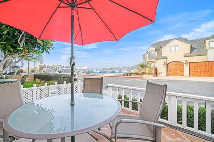Front patio overlooking the bay, offering a serene setting to unwind and soak in Newport Harbor’s coastal charm