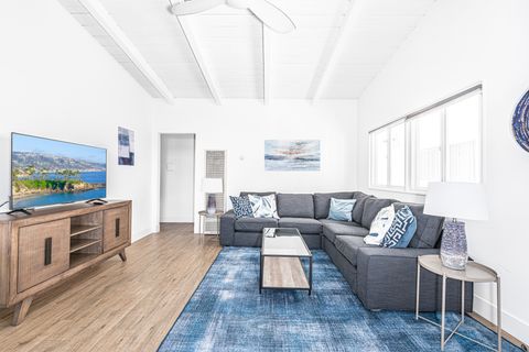 Clean with crisp white touches, the main living area includes a sofa with streaming TV.