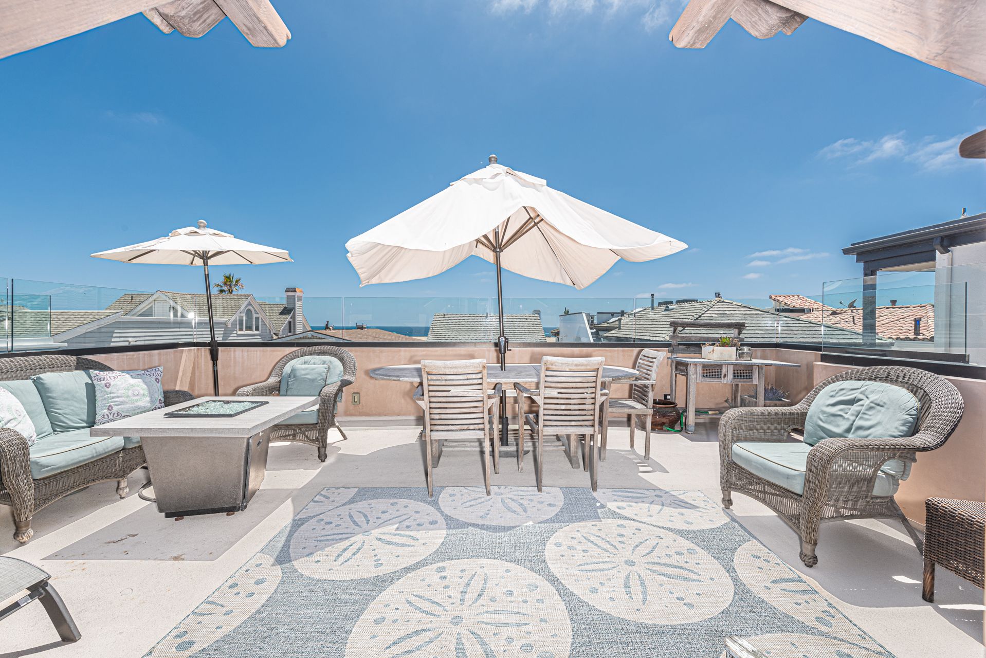 The rooftop deck includes ample seating, a large dining area, market umbrellas, propane gas BBQ grill, and ocean view make this the perfect hangout spot.
