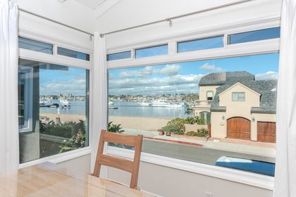 Expansive bay-view windows create a serene backdrop, where passing boats add to the rhythm of relaxed coastal living