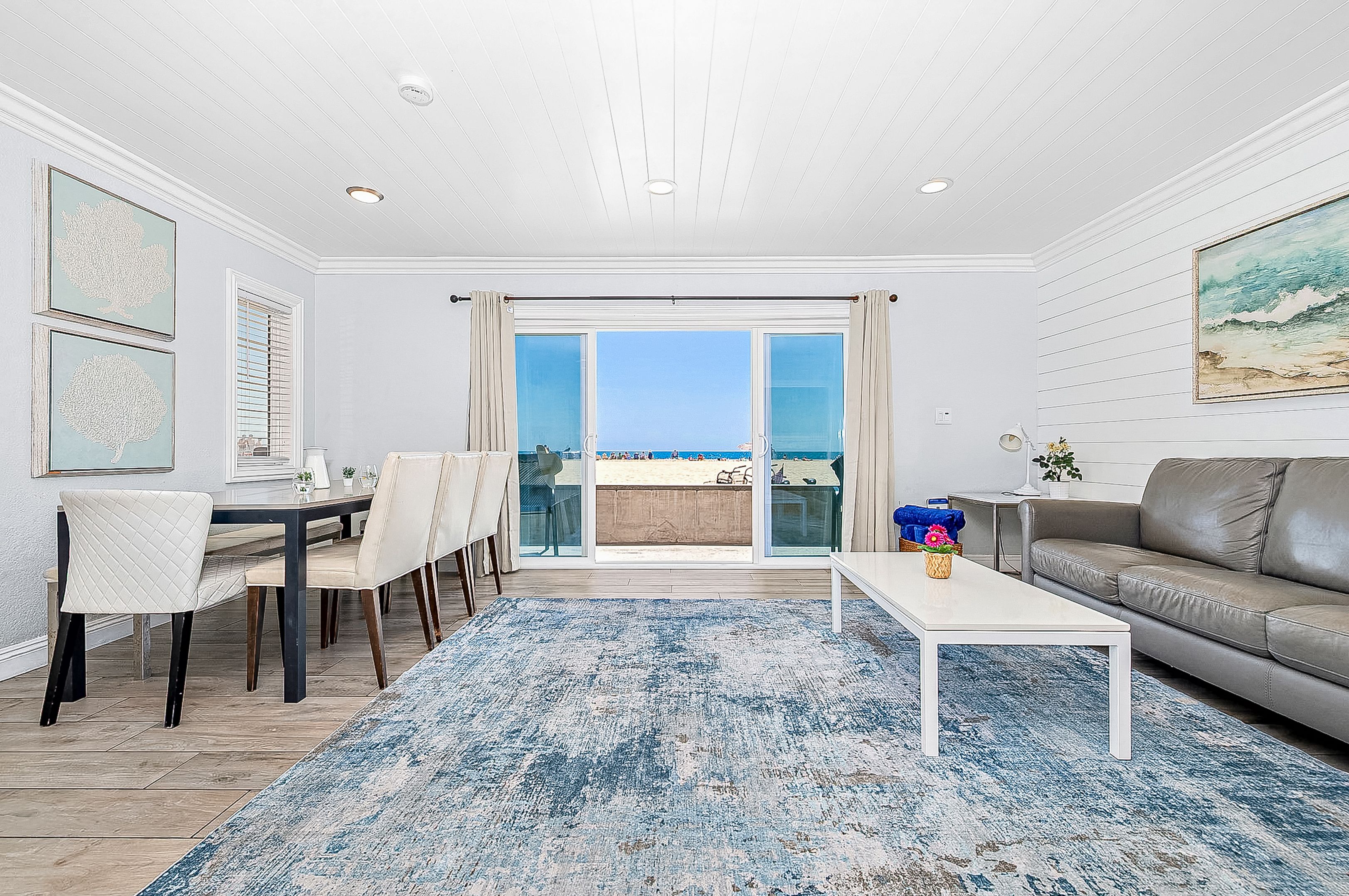 Sliding doors open from the main living area out to the front patio, boardwalk, and beach beyond!