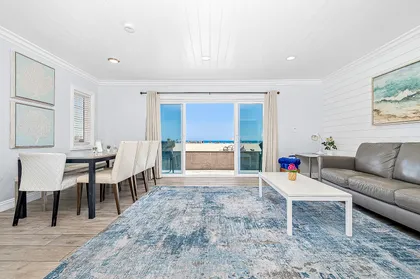 Sliding doors open from the main living area out to the front patio, boardwalk, and beach beyond!