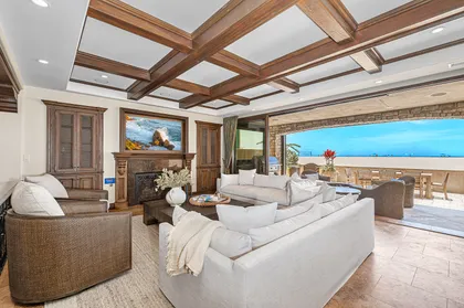 The oceanfront living room opens directly to the patio, keeping the beach and ocean in view