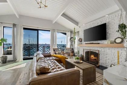 Cozy up by the fireplace while taking in panoramic Newport Harbor views