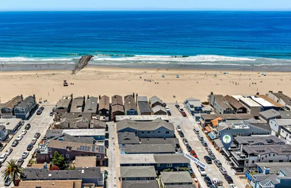 From above, your enviable location says it all, just steps from the sand, with the shoreline practically at your doorstep