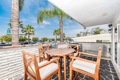 The front patio includes outdoor seating for four and a propane gas BBQ grill, for evening cookouts.