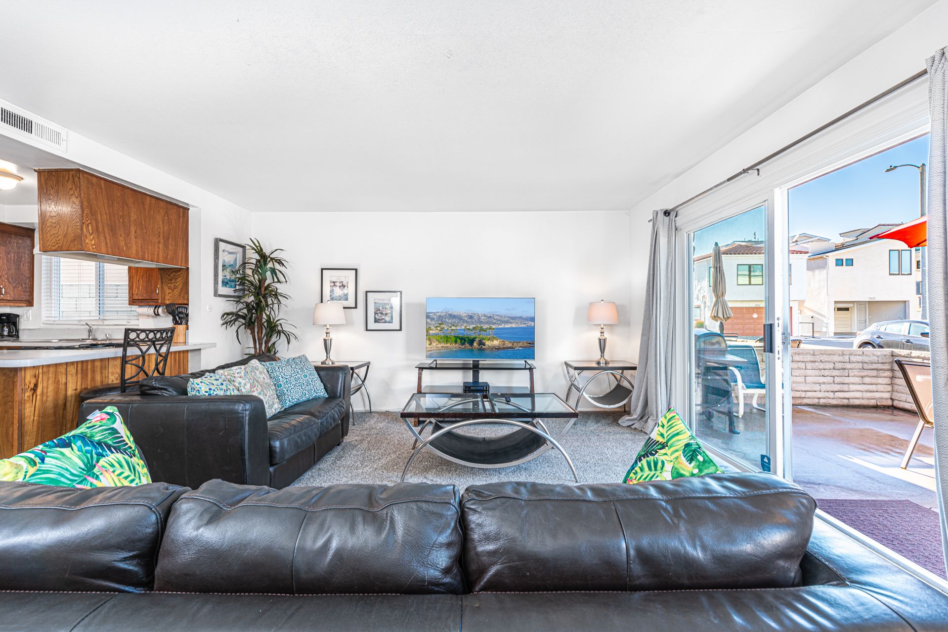 View of main living spaces from the front entry. Open floor plan between living, kitchen and dining areas.
