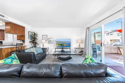 View of main living spaces from the front entry. Open floor plan between living, kitchen and dining areas.