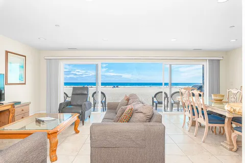 Sliding glass doors open to let in the gentle ocean breezes. Due to the moderate climate, this home, like most in the area, does not include central air.