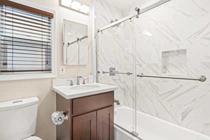 The bathroom is located off of the hallways and has a tub/shower combo.