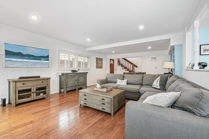 An open-concept layout connects the living room, dining area, casual breakfast nook, and kitchen