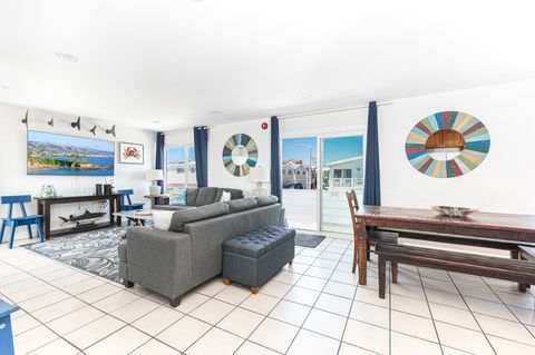 The main living area includes a sofa set, cable TV, and a sliding glass door that opens to the front patio.