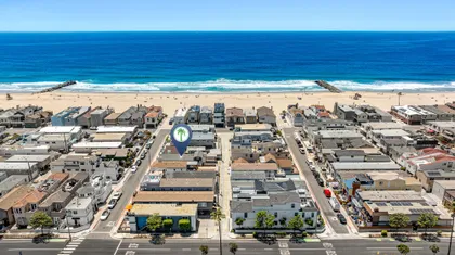 Aerial perspective showcasing the home's prime location just steps from the sand and surf