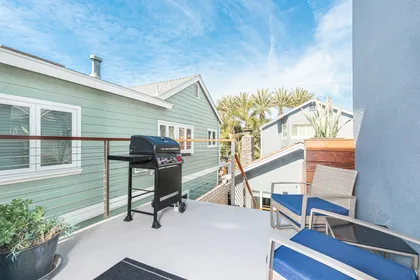 Stairs lead to this upper rear studio, with outdoor seating and grill area.