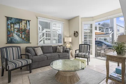 View of living space from the main entry door. Open floor plan between living, kitchen and dining areas.