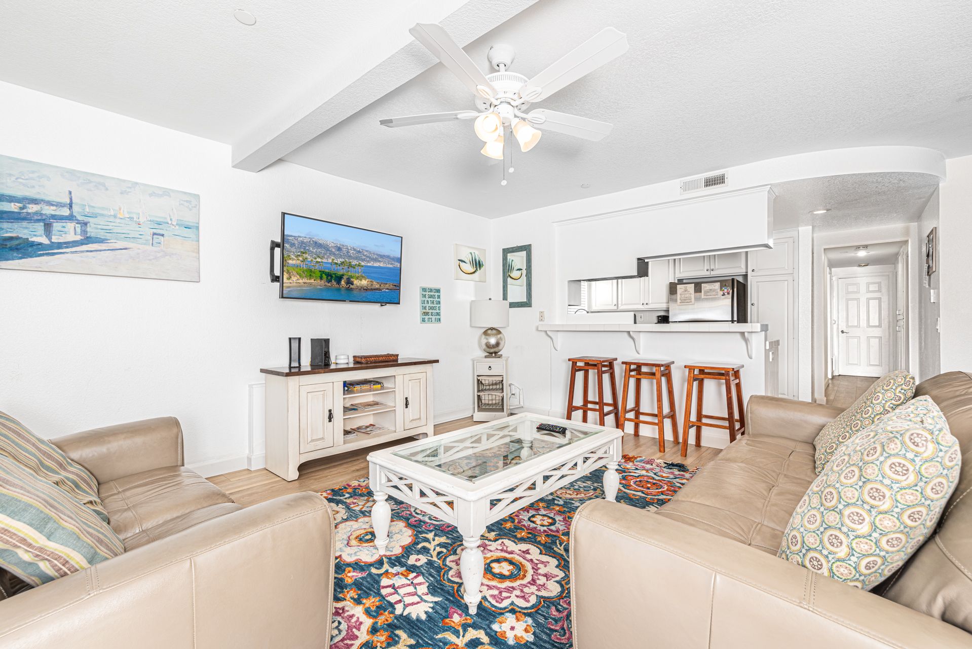 View of main living spaces from the front entry. Open floor plan between living, kitchen and dining areas.