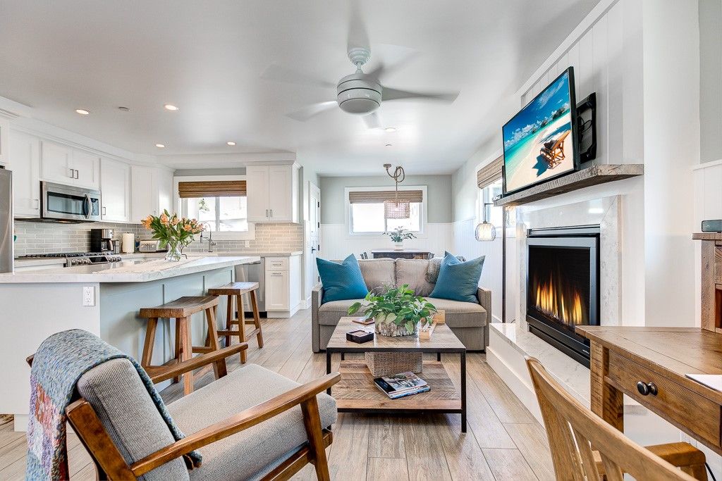 This downstairs unit includes a cozy living area, with gas fireplace and flat screen TV. Beyond the living area is a dining table which seats 4 comfortably.