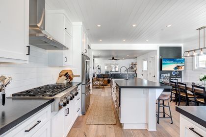 The front door is located on the second floor of this building and opens to the main living area, with kitchen, dining, and living room.
