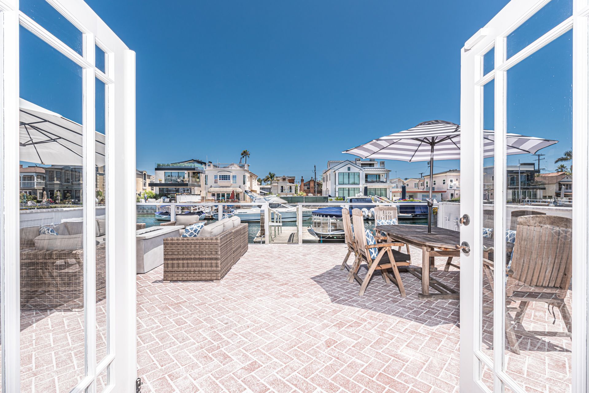 French doors open out to the expansive sun deck, which overlooks the quiet canals of the Newport Harbor.
