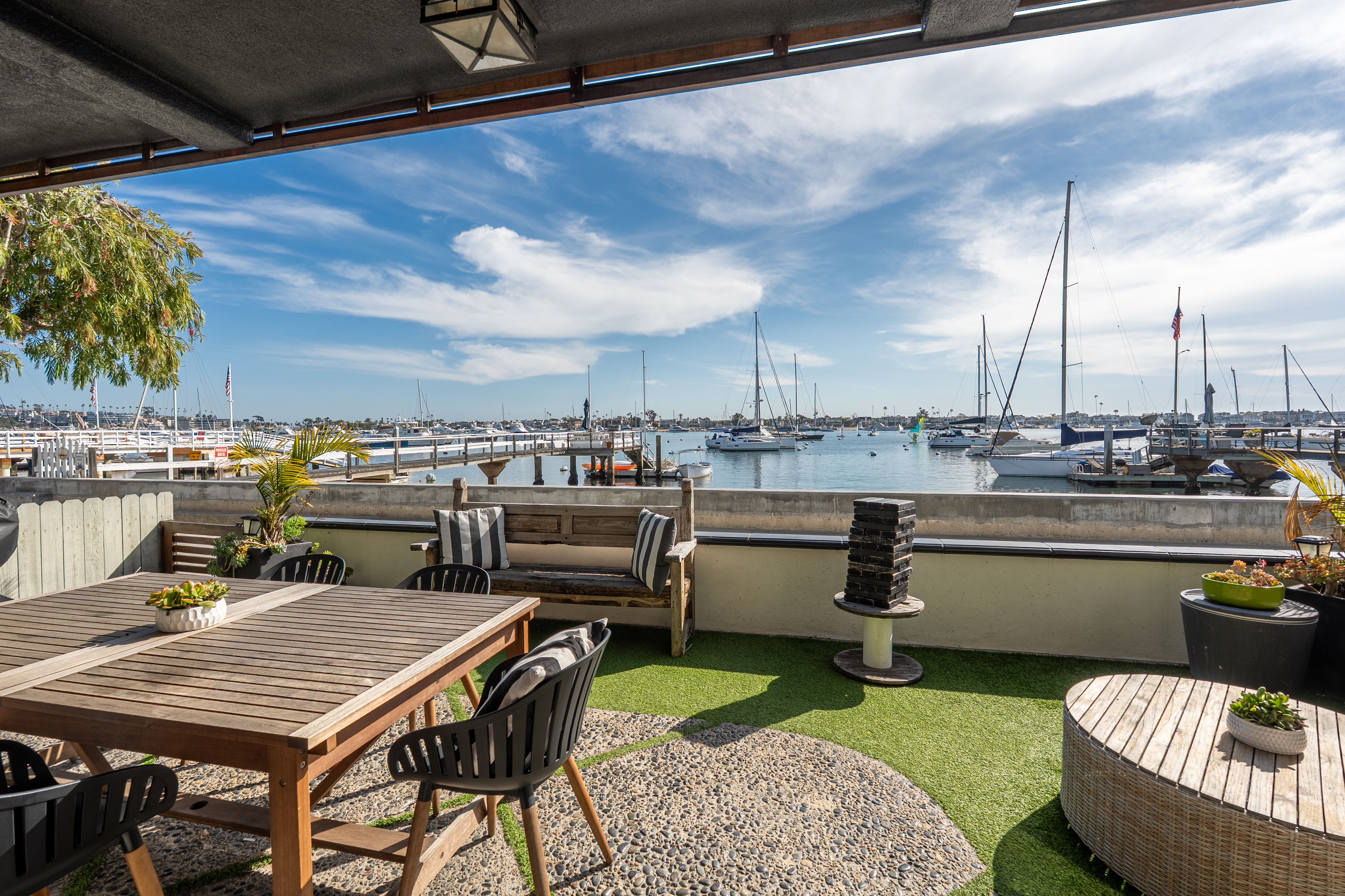Bayfront patio with front-row views of Newport Harbor and Balboa Island boats