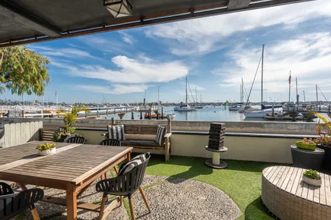 Bayfront patio with front-row views of Newport Harbor and Balboa Island boats