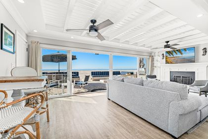 Soak in panoramic ocean views from the comfort of the living room, where wall-to-wall windows flood the space with coastal light