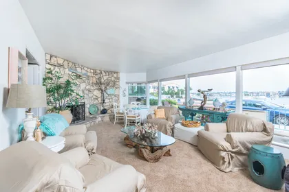The main living area includes a large bay view seating area as well as a round dining/game table for 4.