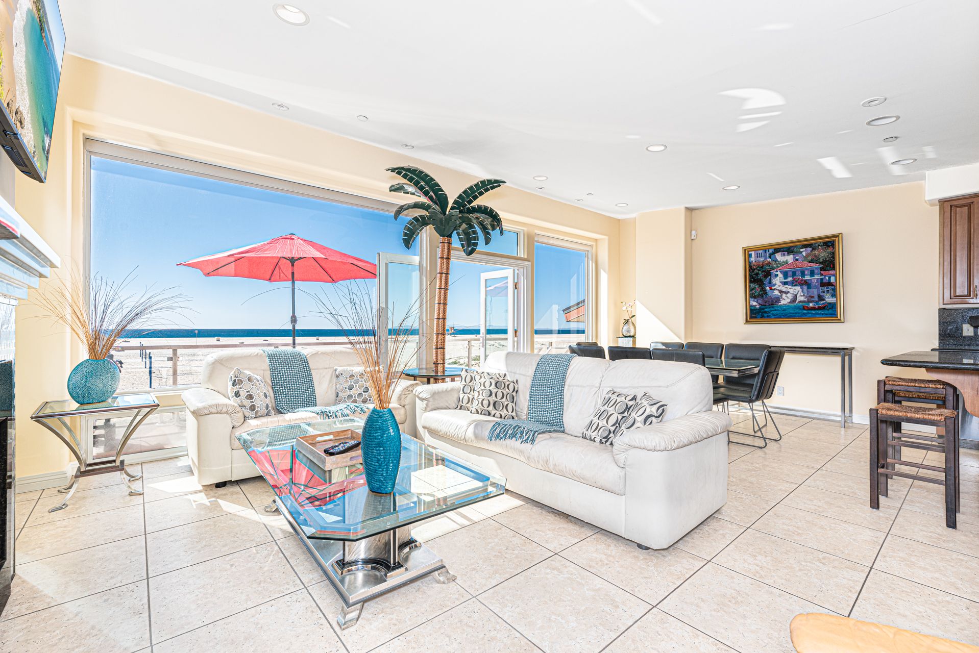 The living area includes a sofa with additional seating and a streaming TV.