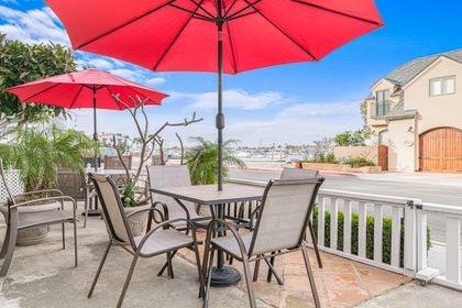 The front patio offers sweeping views of the bay, creating an inviting setting for relaxed coastal moments