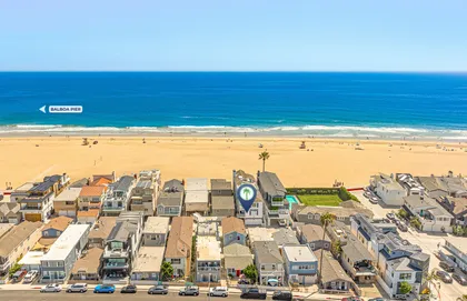 Aerial view highlighting the prime oceanfront location of this Newport Beach property, just steps from the sand and surf