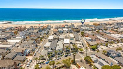 A rare oceanfront setting, this bird’s-eye view highlights the home’s premier location with the beach right outside your door