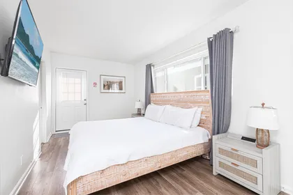 Light-filled primary bedroom with refined coastal simplicity