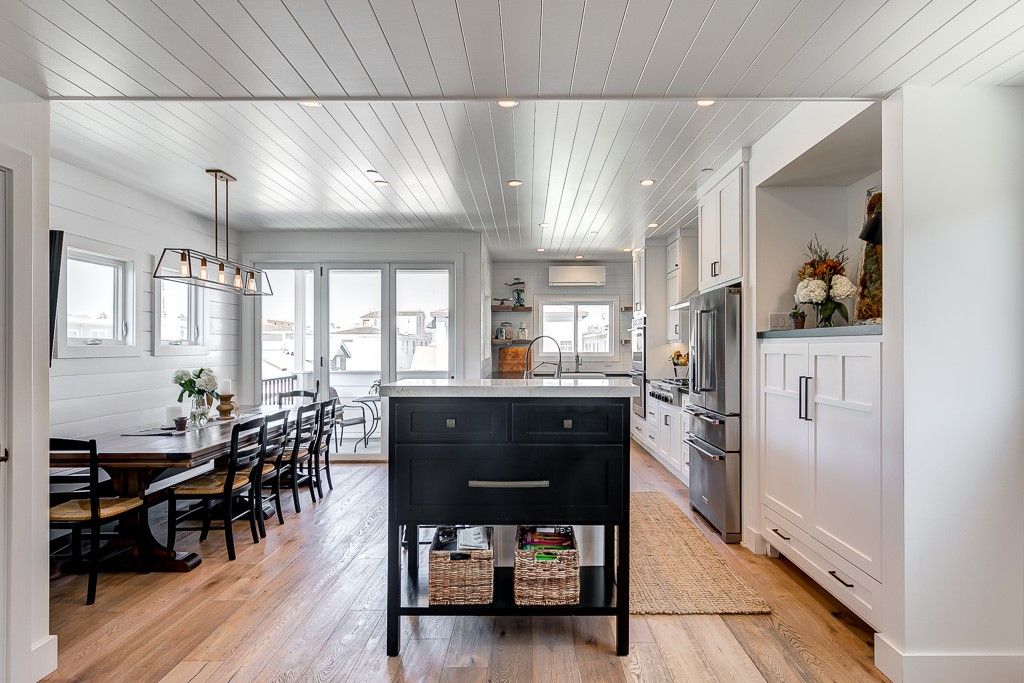 Vantage point from the living room looking out to the kitchen, dining, and small patio beyond.
