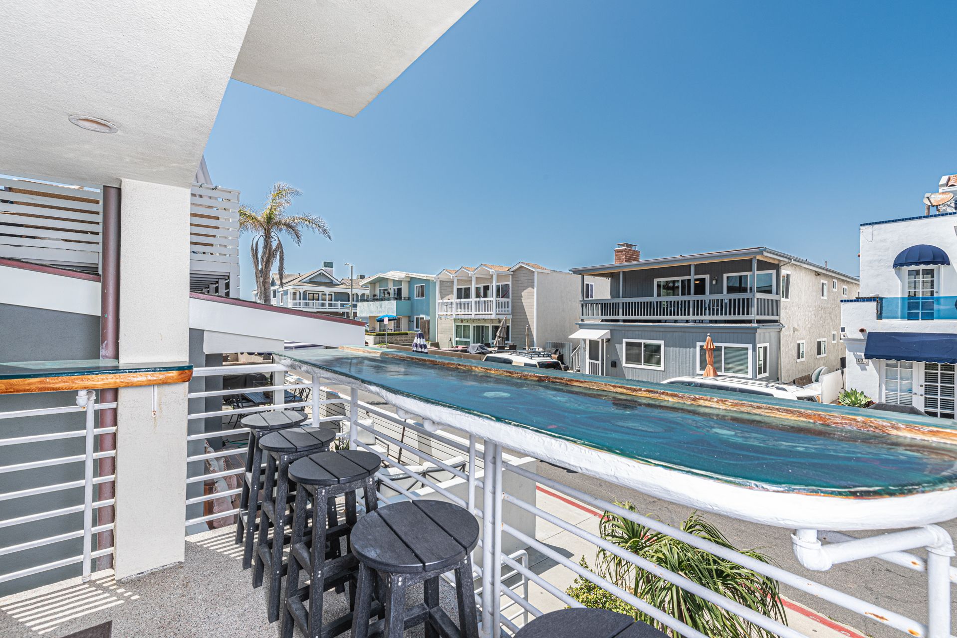 Middle level front balcony - one of three total balconies - with ocean view, cafe' seating and propane BBQ grill. Accessed from living room.