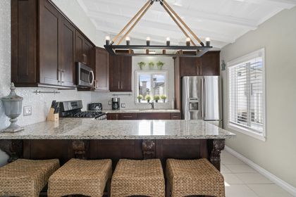 Kitchen is stocked with dishes, cooking, baking and meal prep gear. All standard large and small appliances included (but no dishwasher) and barstool seating.